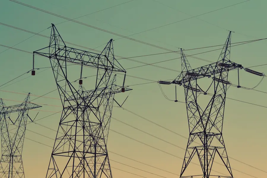 High-voltage transmission tower at sunset